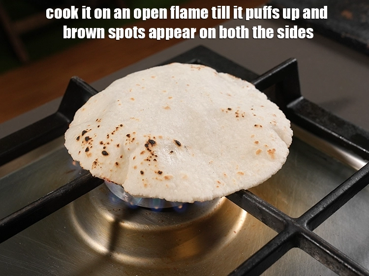 Step 24 – <p>Cook it on an open flame till it puffs up and brown spots appear on …