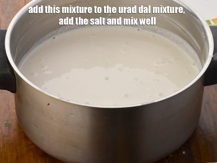Step 14 – <p><span style="background-color:rgb(255,255,255);color:rgb(0,0,0);">Add this <strong>mixture to the urad dal mixture</strong>, add the </span><a href="https://www.tarladalal.com/glossary-salt-namak-table-salt-418i"><u>salt </u></a><span style="background-color:rgb(255,255,255);color:rgb(0,0,0);">to …