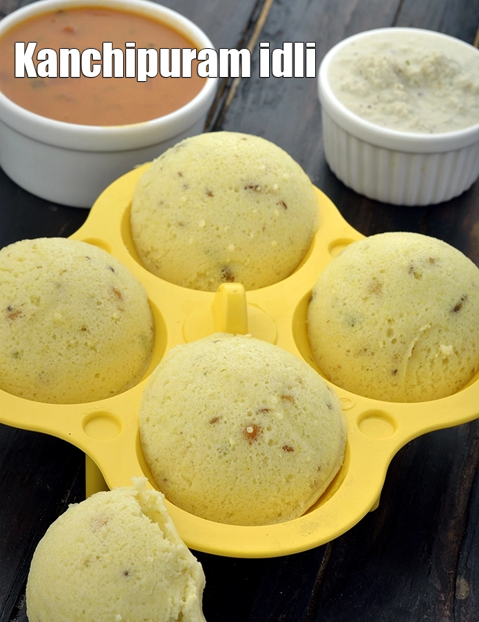 Step 27 – <p><span style="background-color:rgb(255,255,255);color:rgb(0,0,0);">Serve the <strong>Kanchipuram Idli</strong> immediately with </span><a href="https://www.tarladalal.com/sambhar-3578r"><strong><u>sambhar</u></strong></a><span style="background-color:rgb(255,255,255);color:rgb(0,0,0);"> and </span><a href="https://www.tarladalal.com/coconut-chutney---idlis-and-dosas-1653r"><strong><u>coconut chutney</u></strong></a><span style="background-color:rgb(255,255,255);color:rgb(0,0,0);">.</span></p>