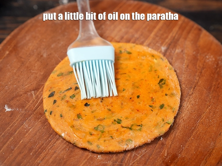 Step 22 – <p>Put a little bit of <a href="https://www.tarladalal.com/glossary-oil-671i"><u>oil</u></a> on the paratha.</p>