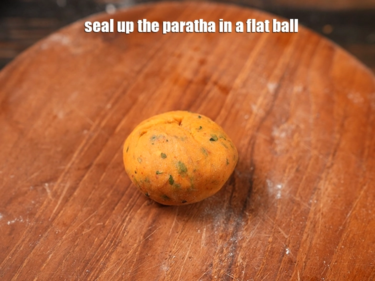 Step 23 – <p>Seal up the <strong>paratha</strong> in a flat ball.</p>