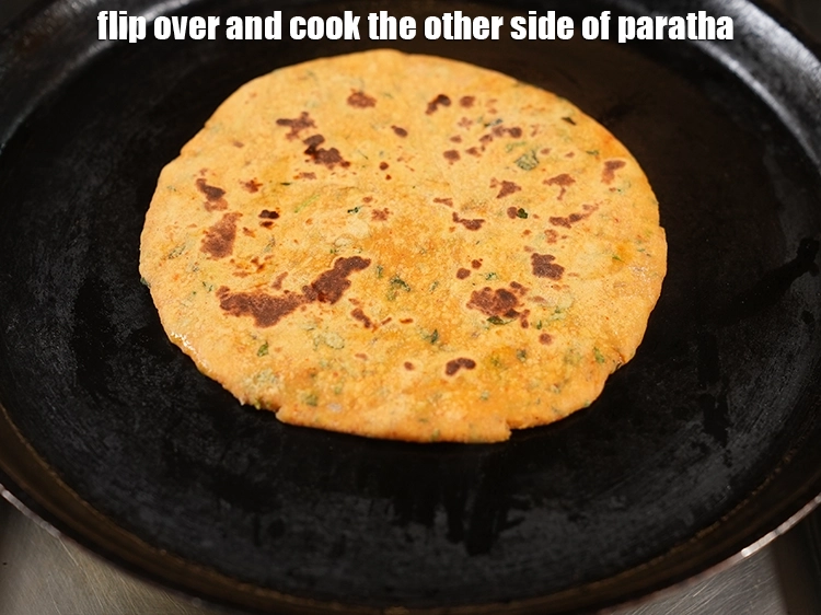 Step 28 – <p>Flip over and cook the other side of <strong>paratha</strong>.&nbsp;</p>