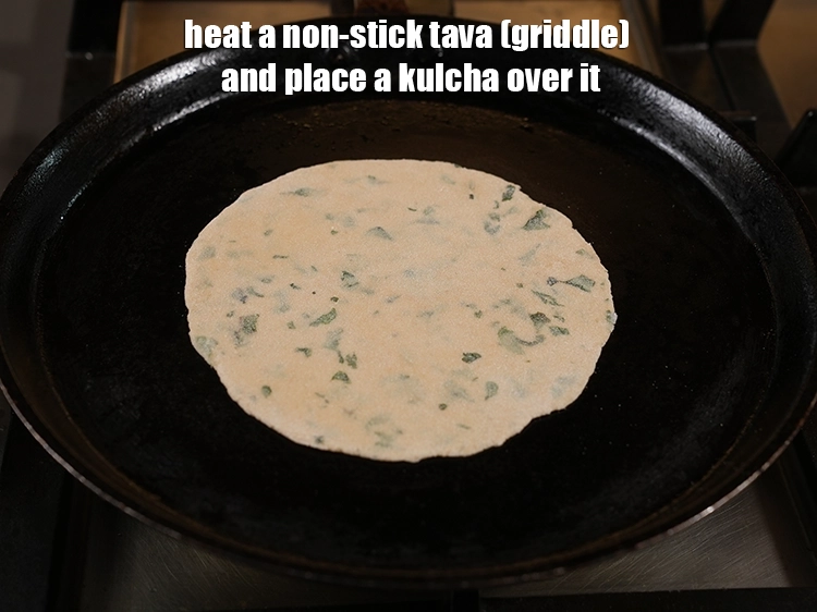 Step 20 – <p>Heat a non-stick tava (griddle) and place a <strong>kulcha</strong> over it.</p>