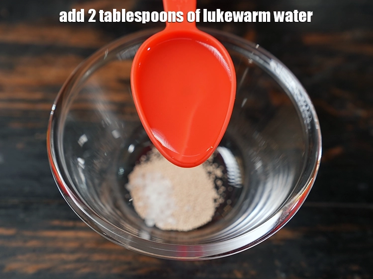 Step 4 – <p>Add <span style="background-color:rgb(255,255,255);color:rgb(0,0,0);">2 tablespoons of <strong>lukewarm</strong> <strong>water</strong>.</span></p>
