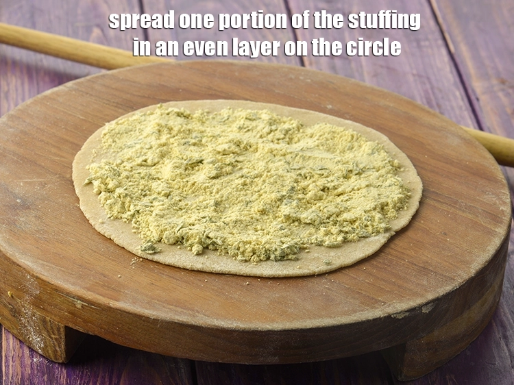Step 46 – <p>Spread one portion of the <strong>stuffing</strong> in an even layer on the circle.</p>