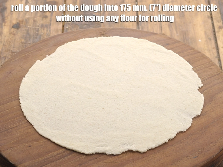 Step 9 – <p>Roll a portion of the dough into 175 mm. (7”) diameter circle without using any …