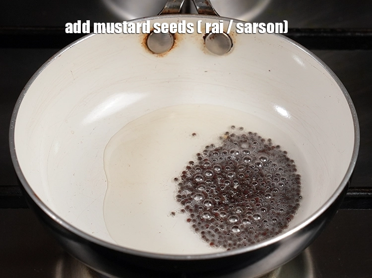 Step 12 – <p>Add <span style="background-color:rgb(255,255,255);color:rgb(0,0,0);">1 tsp </span><a href="https://www.tarladalal.com/glossary-mustard-seeds-sarson-rai-sarson-ke-beej-525i"><u>mustard seeds ( rai / sarson)</u></a><u>.</u></p>