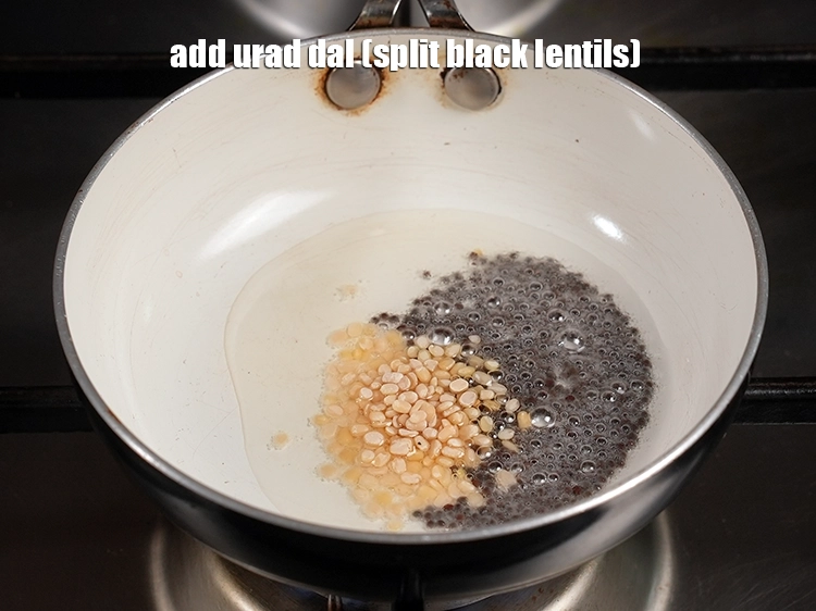 Step 13 – <p>Add <span style="background-color:rgb(255,255,255);color:rgb(0,0,0);">2 tsp </span><a href="https://www.tarladalal.com/glossary-urad-dal-split-black-lentil-941i"><u>urad dal (split black lentils)</u></a><u>.</u></p>