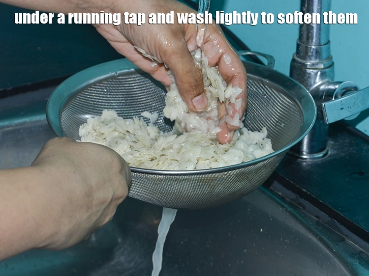 Step 13 – <html><head><meta charset="UTF-8"></head><body><p>Place the <strong>beaten rice</strong> on a sieve under a running tap and wash lightly …