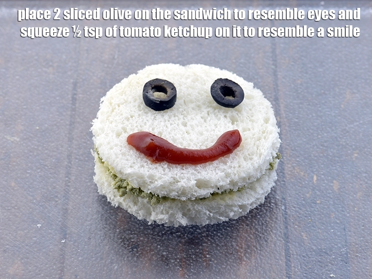 Step 7 – <p><span style="background-color:rgb(255,255,255);color:rgb(0,0,0);">Place 2 </span><a href="https://www.tarladalal.com/glossary-black-olives-kale-jaitun-449i#ing_2783"><u>sliced black olives</u></a><span style="background-color:rgb(255,255,255);color:rgb(0,0,0);"> on the <strong>sandwich</strong> to resemble eyes and …