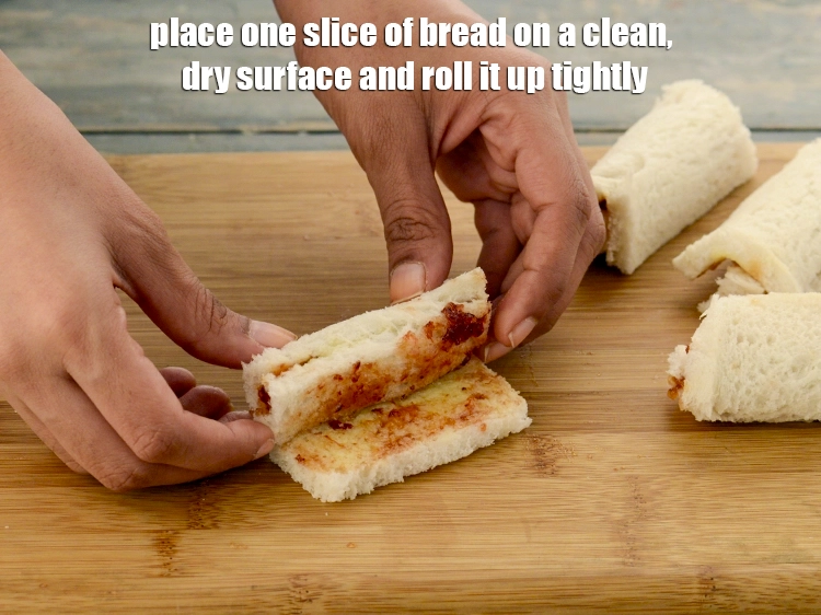 Step 20 – <p>Place one slice of bread on a clean, dry surface and roll it up tightly.&nbsp;</p>