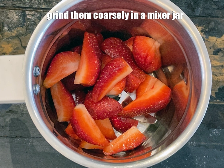 Step 4 – <p>Mash the <a href="https://www.tarladalal.com/glossary-strawberry-strawberries-436i">strawberries</a> using a pestle or grind them coarsely in a mixer jar.</p>