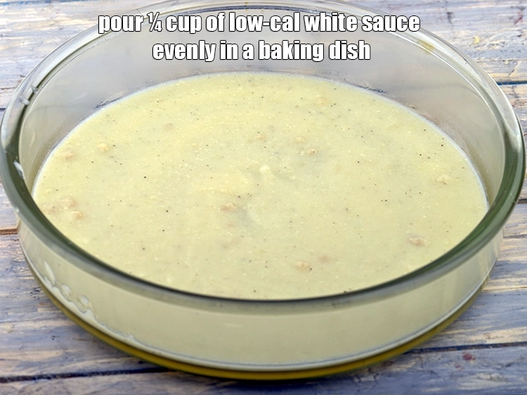 Step 13 – <p>Pour ¼ cup of <a href="https://www.tarladalal.com/low-calorie-white-sauce--diabetic-recipe-35331r">low-cal white sauce</a> evenly in a baking dish.</p>
