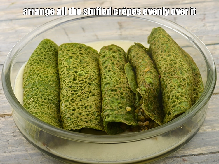 Step 14 – <p><span style="color:rgb(13,13,13);">Arrange all the stuffed <strong>crêpes</strong> evenly over it.</span></p>
