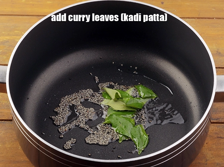 Step 7 – <p>When the seeds crackle, add 8 to 10&nbsp;<a href="https://www.tarladalal.com/glossary-curry-leaves-kadi-patta-kadipatta-388i">curry leaves (kadi patta)</a>.</p>
