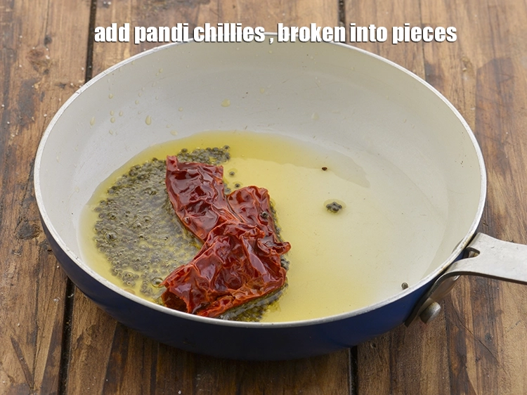 Step 11 – <p>When the seeds crackle, add <span style="background-color:rgb(255,255,255);color:rgb(0,0,0);">1 </span><a href="https://www.tarladalal.com/glossary-pandi-chillies-pandi-dry-red-chillies-2373i"><u>pandi chillies </u></a><span style="background-color:rgb(255,255,255);color:rgb(0,0,0);">, broken into pieces.</span></p>