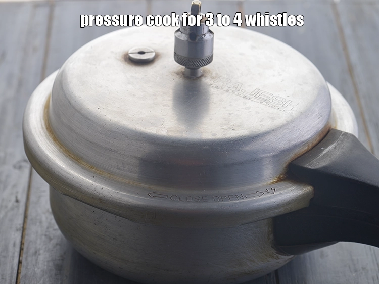 Step 15 – <p>Cover the pressure cooker with the lid and pressure cook for <strong>3 to 4 whistles</strong>. …