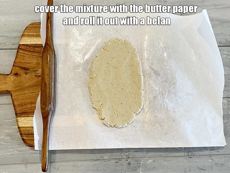 Step 15 – <p><span style="background-color:rgb(255,255,255);color:rgb(0,0,0);">Cover the mixture with the butter paper and roll it out with a belan.</span></p>
