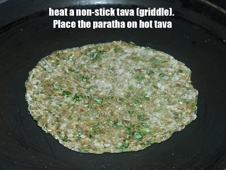 Step 17 – <p>Heat a non-stick tava (griddle).Place the paratha on hot tava.</p>