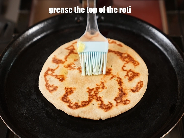 Step 22 – <p><span style="background-color:rgb(255,255,255);color:rgb(0,0,0);">Grease the top of the roti. Cook on a low flame for 90 seconds …