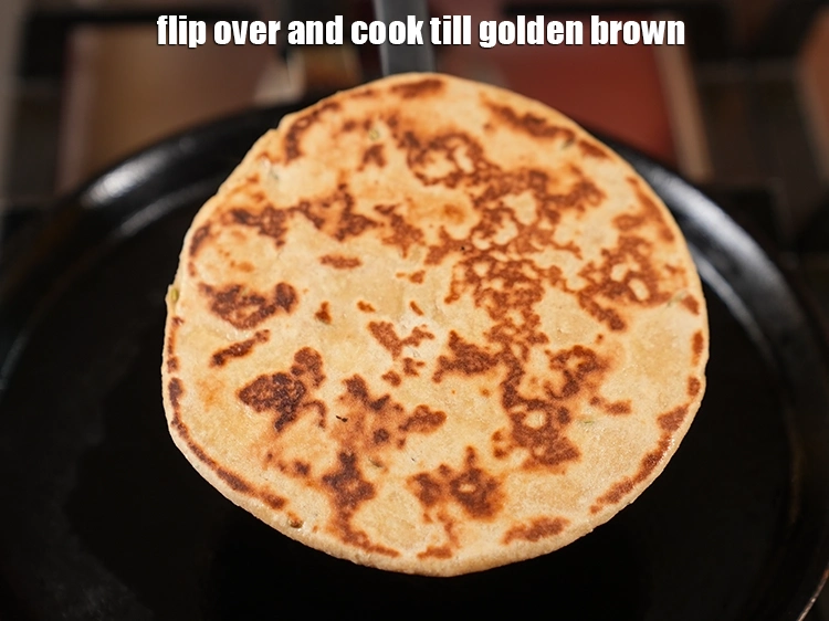 Step 23 – <p>Flip over and cook till golden brown on a low flame for 90 seconds.&nbsp;Your roti …