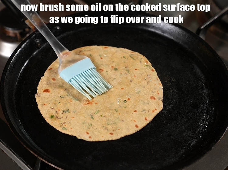 Step 19 – <p>Now brush some <a href="https://www.tarladalal.com/glossary-oil-671i"><u>oil</u></a> on the cooked surface top as we going to flip …