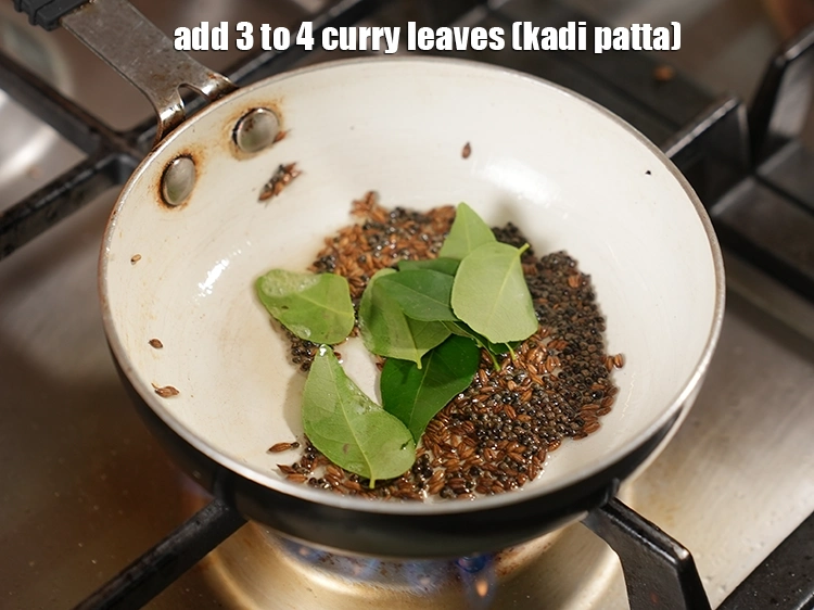 Step 21 – <html><head></head><body><p>Add&nbsp;3 to 4&nbsp;<a href="glossary-curry-leaves-kadi-patta-kadipatta-388i">curry leaves (kadi patta)</a>.</p></body></html>