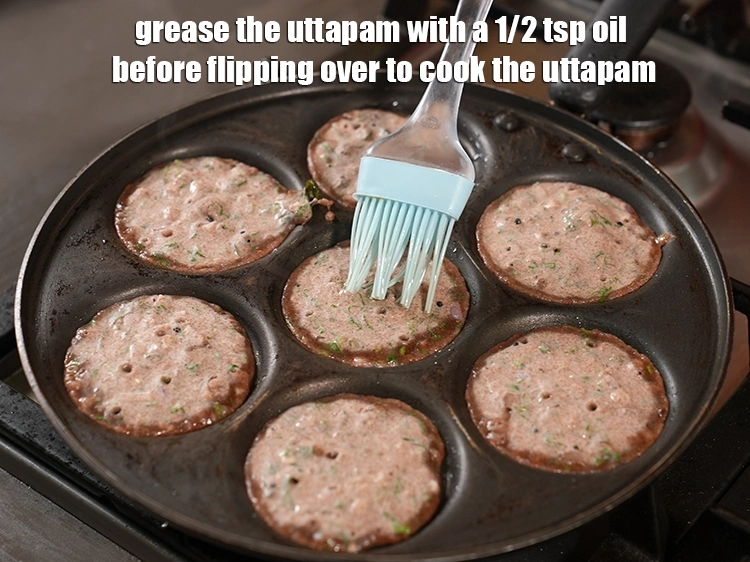 Step 28 – <p>Grease the&nbsp;<strong>uttapam</strong> with a 1/2&nbsp;tsp <a href="https://www.tarladalal.com/glossary-oil-671i"><u>oil </u></a>&nbsp;before flipping over to cook the <strong>uttapam</strong>.</p>