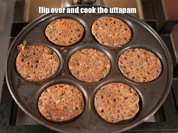Step 29 – <p>Flip over and cook the <strong>uttapam</strong>.</p>