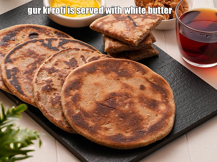 Step 29 – <p><strong>gur ki roti</strong> is served with <a href="https://www.tarladalal.com/how-to-make-homemade-white-butter-safed-makhan-recipe-42484r"><u>white butter (safed makhan)</u></a>.</p>