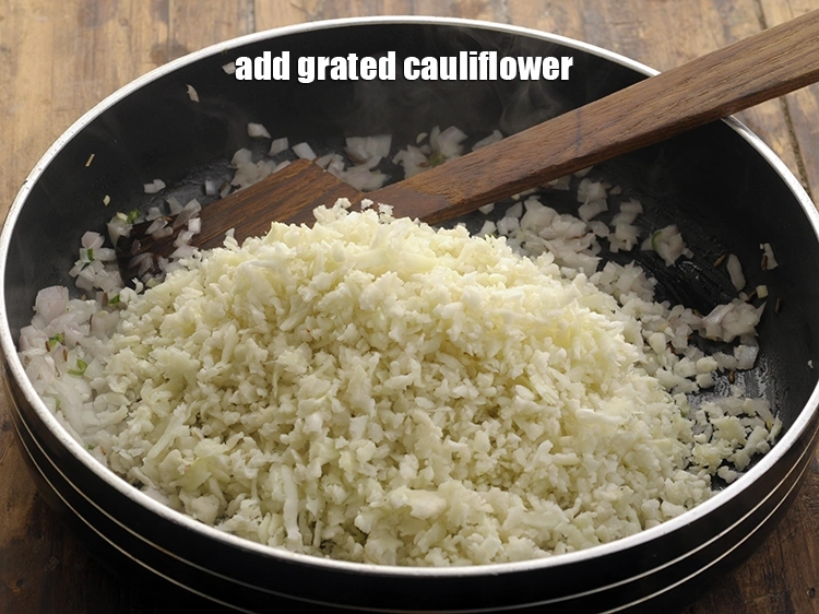 Step 16 – <p>Add the <span style="background-color:rgb(255,255,255);color:rgb(0,0,0);">1 1/2 cups </span><a href="https://www.tarladalal.com/glossary-cauliflower-phool-gobi-phool-gobhi-174i#ing_2418"><u>grated cauliflower</u></a><u>.</u></p>