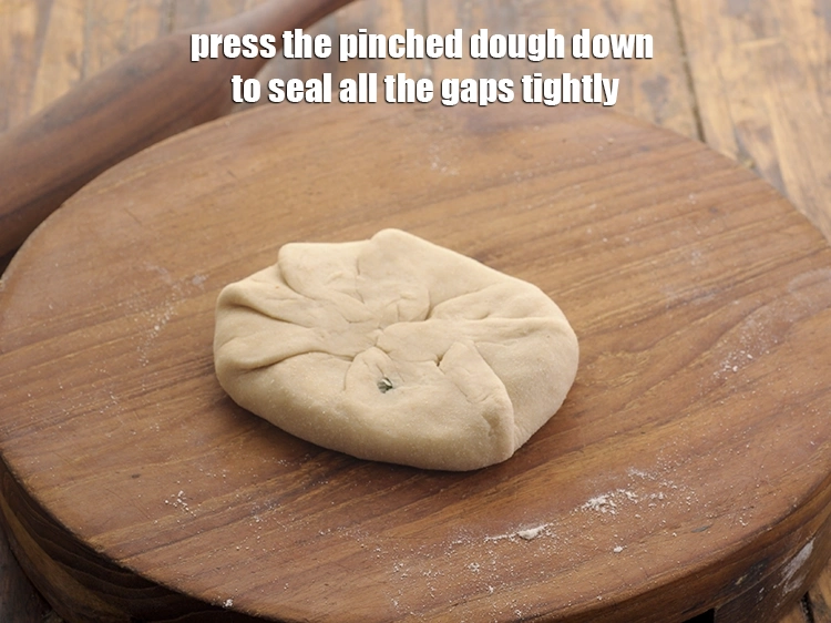 Step 28 – <p>Press the pinched dough down to seal all the gaps tightly.</p>