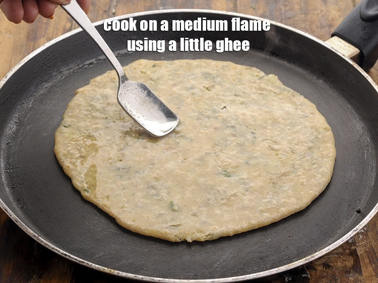 Step 31 – <p>Cook on a medium flame using a little <a href="https://www.tarladalal.com/glossary-ghee-245i"><u>ghee</u></a>, till golden brown spots appear …