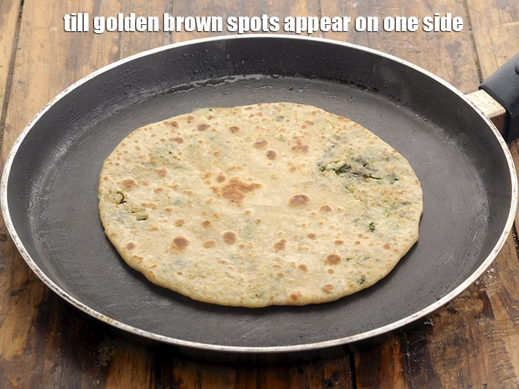 Step 33 – <p>Press with a spatula and cook on both sides using <a href="https://www.tarladalal.com/glossary-ghee-245i"><u>ghee</u></a> until the <strong>gobi …