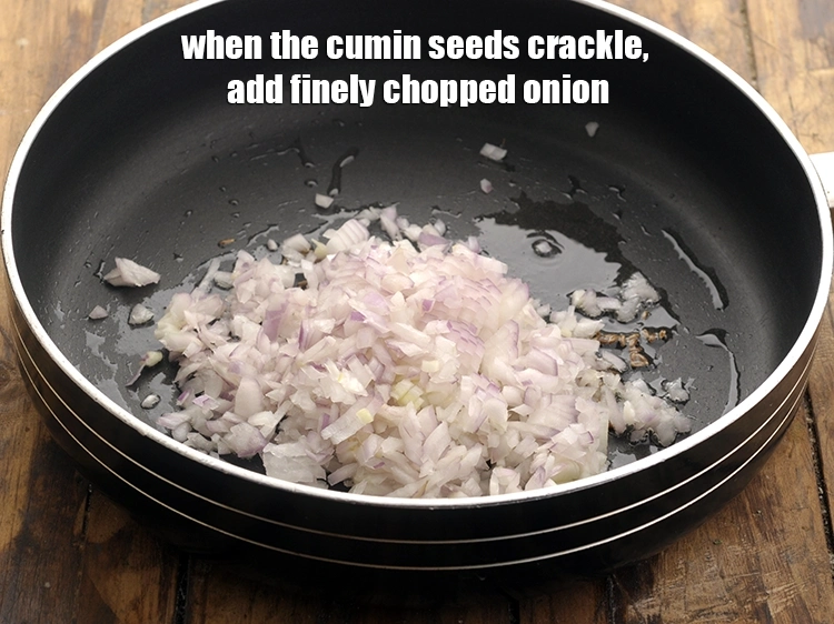 Step 13 – <p>When the cumin seeds crackle, add the <span style="background-color:rgb(255,255,255);color:rgb(0,0,0);">1/2 cup finely </span><a href="https://www.tarladalal.com/glossary-onions-pyaz-pyaaz-kanda-548i#ing_2327"><u>chopped onion</u></a>.</p>