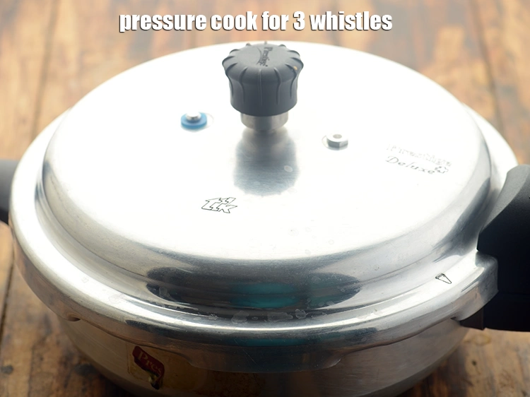 Step 14 – <p>Close the lid of the pressure cooker and pressure cook for 3 whistles.</p>