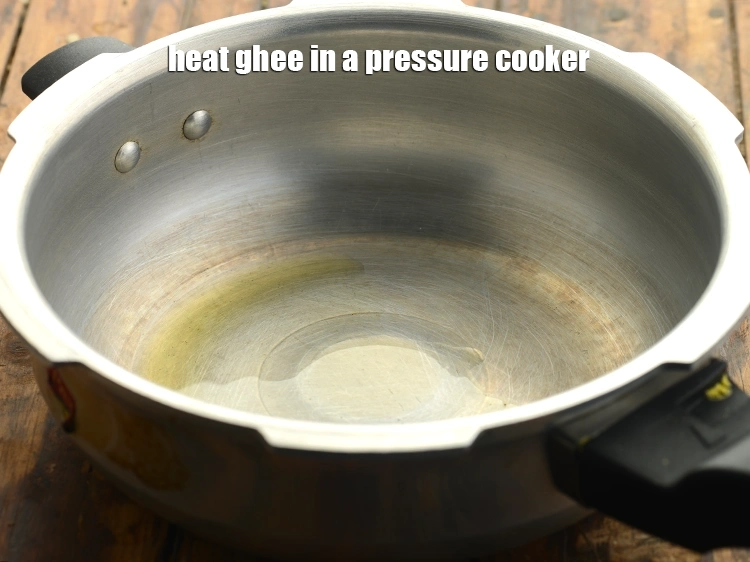 Step 10 – <p>Next heat <span style="background-color:rgb(255,255,255);color:rgb(0,0,0);">1/2 tsp </span><a href="https://www.tarladalal.com/glossary-ghee-245i"><u>ghee</u></a> in a pressure cooker.</p>