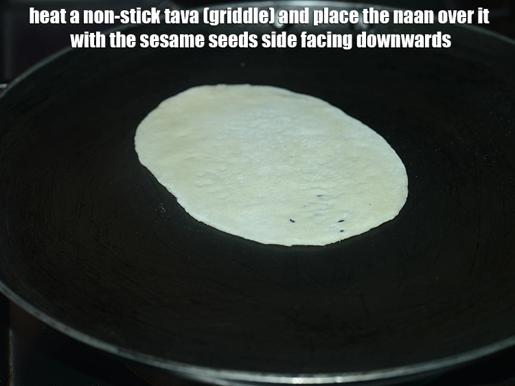 Step 22 – <p>Heat a non-stick tava (griddle) and place the naan over it with the sesame seeds …