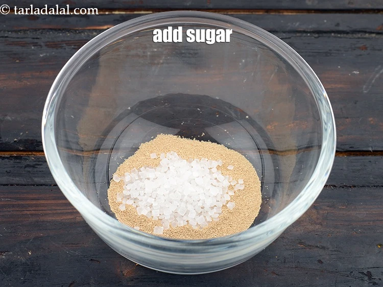 Step 3 – <p>Add <span style="background-color:rgb(255,255,255);color:rgb(0,0,0);">1/2 tsp </span><a href="https://www.tarladalal.com/glossary-sugar-chini-shakkar-278i"><u>sugar</u></a> to it. The yeast will feed on the sugar …