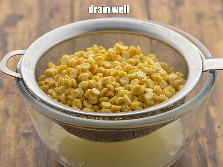 Step 59 – <p><span style="background-color:rgb(255,255,255);color:rgb(0,0,0);">Drain this <strong>chana dal</strong> using a strainer again and discard the water.</span></p>
