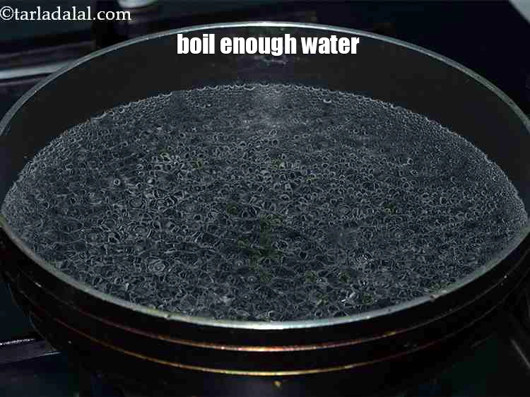 Step 26 – <p>To boil <strong>chana dal</strong>, boil enough water in a deep non-stick pan.</p>