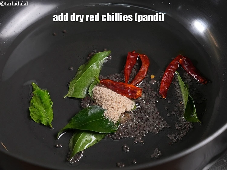 Step 27 – <p>Add the <span style="background-color:rgb(255,255,255);color:rgb(0,0,0);">2 </span><a href="https://www.tarladalal.com/glossary-pandi-chillies-pandi-dry-red-chillies-2373i"><u>pandi chillies </u></a><span style="background-color:rgb(255,255,255);color:rgb(0,0,0);">, broken into pieces.</span></p>