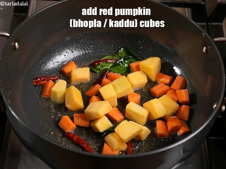 Step 30 – <p>Add the <span style="background-color:rgb(255,255,255);color:rgb(0,0,0);">1/2 cup </span><a href="https://www.tarladalal.com/glossary-red-pumpkin-kaddu-lal-bhopla-bhopla-595i#ing_2471"><u>red pumpkin (bhopla / kaddu) cubes</u></a><u>.</u></p>