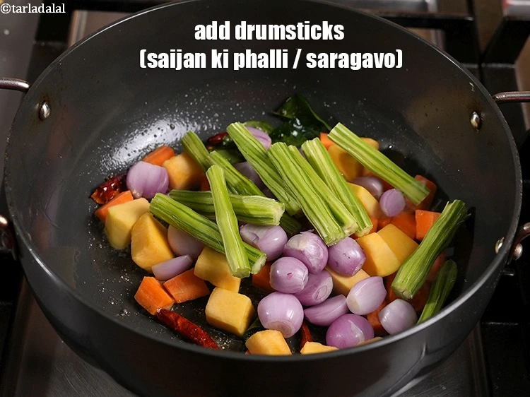 Step 32 – <p>Add the <span style="background-color:rgb(255,255,255);color:rgb(0,0,0);">1/2 cup </span><a href="https://www.tarladalal.com/glossary-drumstick-saijan-ki-phalli-395i"><u>drumsticks (saijan ki phalli / saragavo) </u></a><span style="background-color:rgb(255,255,255);color:rgb(0,0,0);">, cut …
