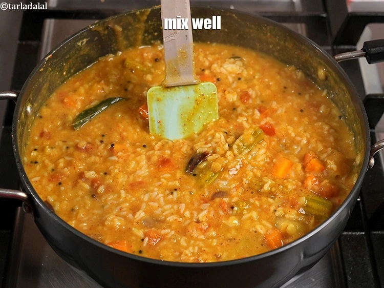 Step 47 – <p>Mix well to blend the dal, rice and vegetables.</p>