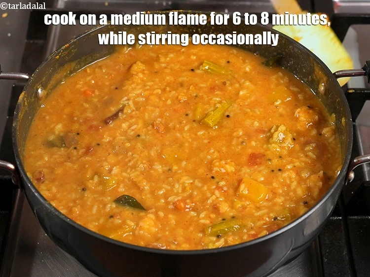 Step 48 – <p>Cook <strong>Sambhar Rice&nbsp;(Sambar Sadan)</strong>&nbsp;on a medium flame for 6 to 8 minutes, while stirring occasionally. …
