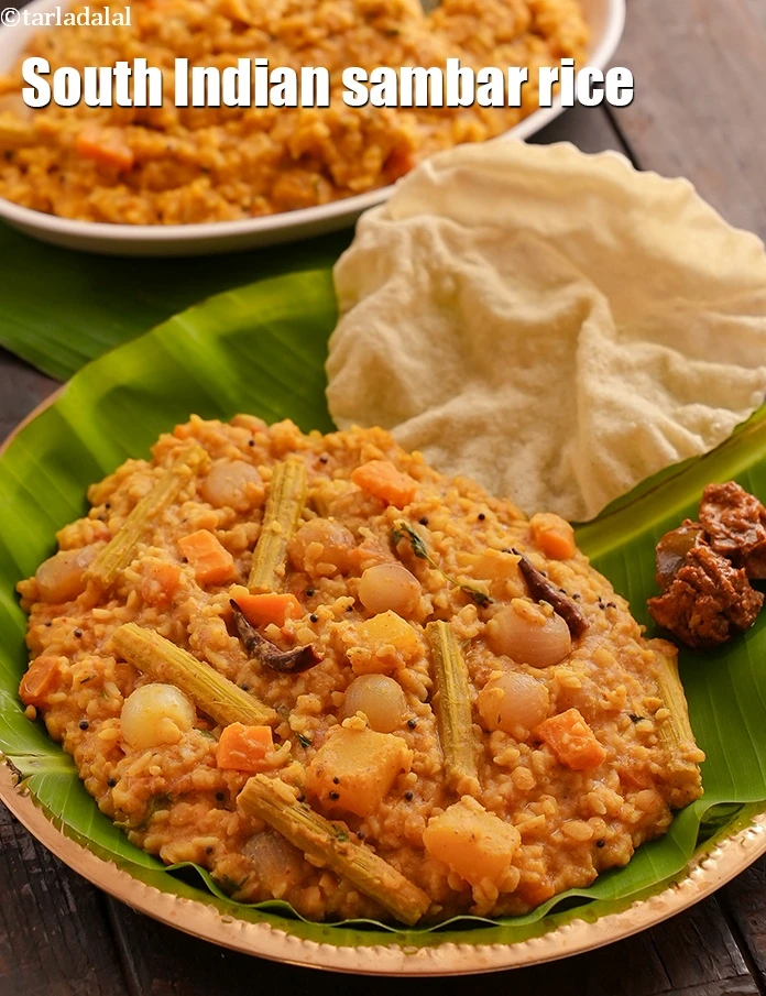 Step 51 – <p>Serve the <strong>Sambar Rice (Sambar Sadan)</strong> hot with <a href="https://www.tarladalal.com/glossary-ghee-245i"><u>ghee</u></a> and <a href="https://www.tarladalal.com/glossary-papad-papadum-562i#ing_3487"><u>Kerala Papadum</u></a>.</p>