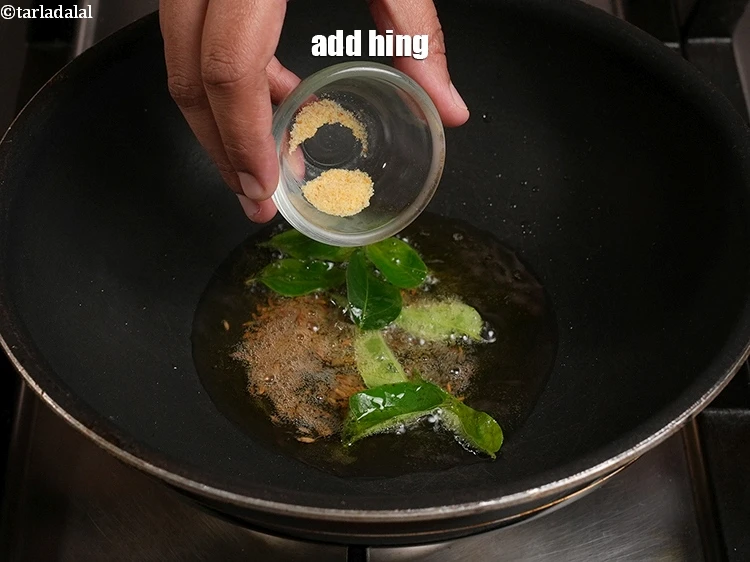 Step 20 – <p>Add 1/8 tsp <a href="https://www.tarladalal.com/glossary-asafoetida-hing-113i">asafoetida (hing)</a>.</p>