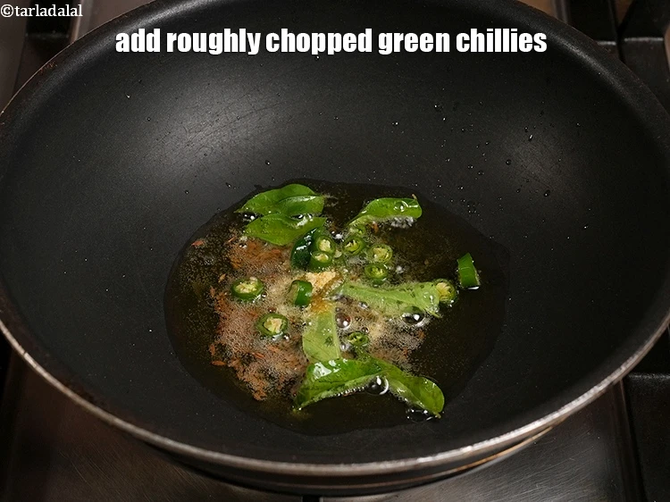 Step 21 – <p>Add 1 tsp roughly&nbsp;<a href="https://www.tarladalal.com/glossary-chopped-green-chilli-820i">chopped green chillies</a>.</p>