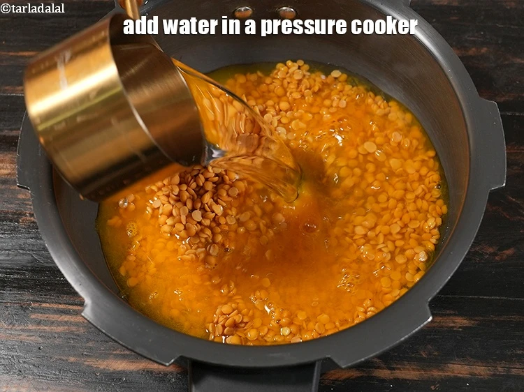 Step 11 – <p>Add 3&nbsp;cups of water in a pressure cooker.</p>